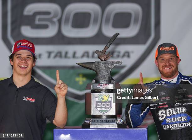 Jeb Burton, driver of the Solid Rock Carriers Chevrolet, celebrates with NASCAR Cup Series driver Harrison Burton in victory lane after winning the...