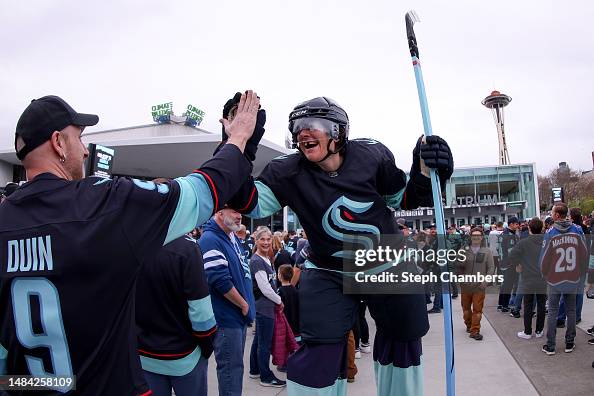 A stilt performer high fives fans before Game Three of the First ...
