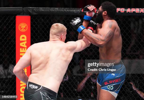 Sergei Pavlovich of Russia punches Curtis Blaydes in a heavyweight fight during the UFC Fight Night event at UFC APEX on April 22, 2023 in Las Vegas,...