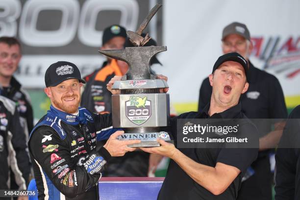 Jeb Burton, driver of the Solid Rock Carriers Chevrolet, and team owner Jordan Anderson celebrate in victory lane after winning the NASCAR Xfinity...