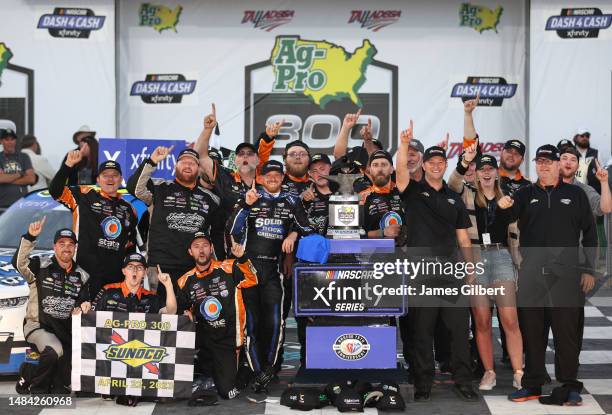 Jeb Burton, driver of the Solid Rock Carriers Chevrolet, and crew celebrate in victory lane after winning the NASCAR Xfinity Series Ag-Pro 300 at...