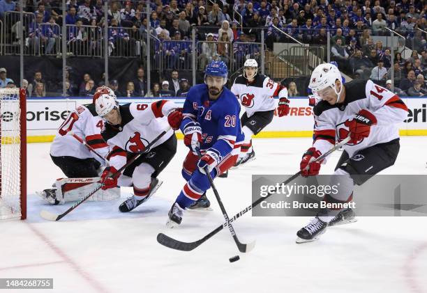 Chris Kreider of the New York Rangers and Nathan Bastian of the New Jersey Devils battle for the puck during the second period during Game Three in...