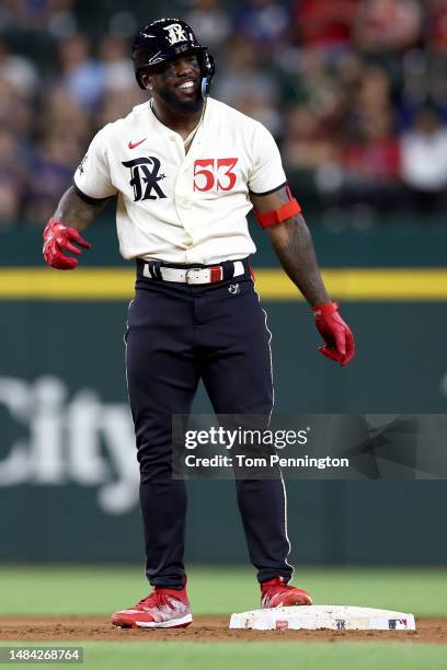 Adolis Garcia of the Texas Rangers celebrates after hitting a two-run double against James Kaprielian of the Oakland Athletics in the bottom of the...