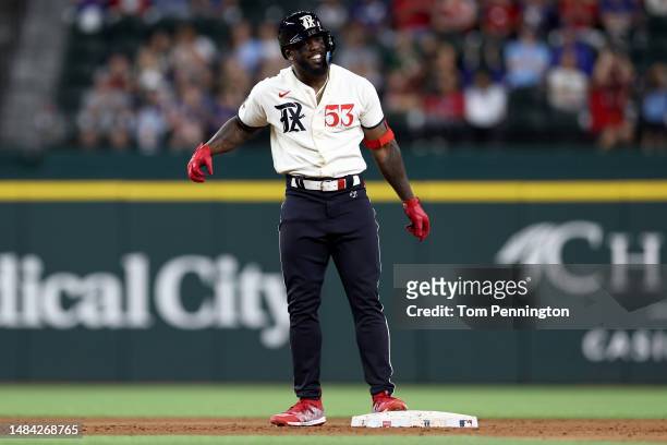 Adolis Garcia of the Texas Rangers celebrates after hitting a two-run double against James Kaprielian of the Oakland Athletics in the bottom of the...