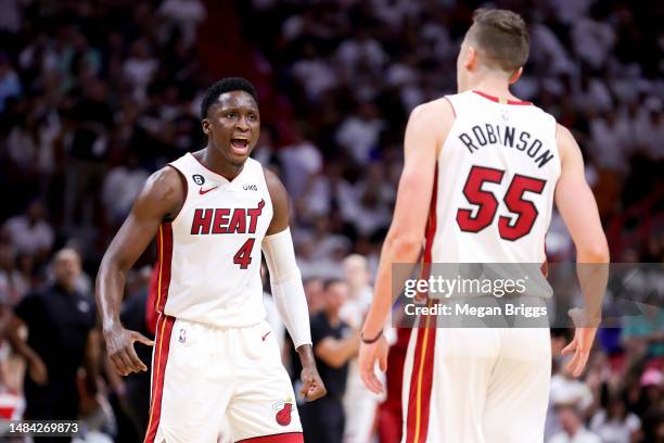 Victor Oladipo and Duncan Robinson of the Miami Heat celebrate during the fourth quarter against the Milwaukee Bucks during Game Three of the Eastern...