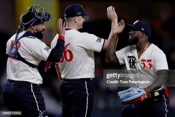 Adolis Garcia of the Texas Rangers celebrates with Josh Sborz of the Texas Rangers and Sandy Leon of the Texas Rangers after the Rangers beat the...