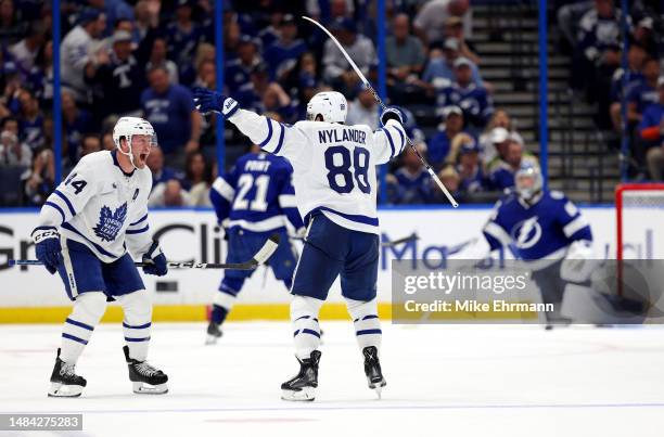 Morgan Rielly and William Nylander of the Toronto Maple Leafs celebrate an overtime goal by Ryan O'Reilly of the Toronto Maple Leafs during Game...