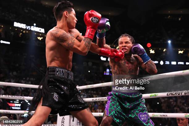 Ryan Garcia in the black trunks exchanges punches with Gervonta Davis in the green and purple trunks in the first round during their catchweight bout...