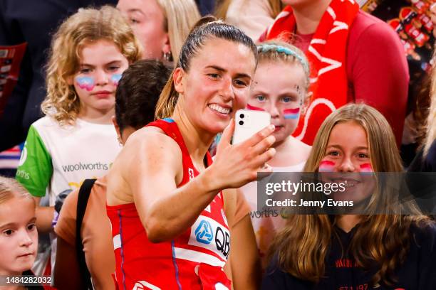 Maddy Proud of the Swifts poses for phone photos with fans after their victory during the round six Super Netball match between NSW Swifts and...