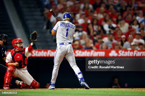 Melendez of the Kansas City Royals is hit by a pitch scoring a run against the Los Angeles Angels in the ninth inning at Angel Stadium of Anaheim on...