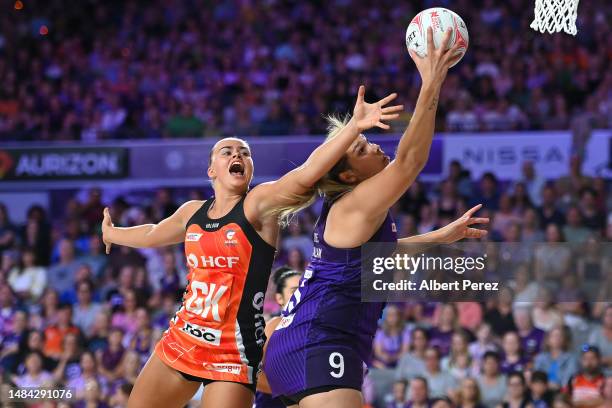 Matilda McDonell of the Giants and Donnell Wallam of the Firebirds compete for the ball during the round six Super Netball match between the...