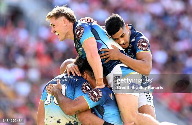 Tino Fa'asuamaleaui of the Titans is congratulated by team mates after scoring a try during the round eight NRL match between the Dolphins and Gold...