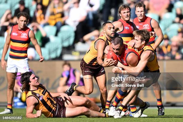 Taylor Walker of the Crows is tackled by Jarman Impey of the Hawks during the round six AFL match between Hawthorn Hawks and Adelaide Crows at...