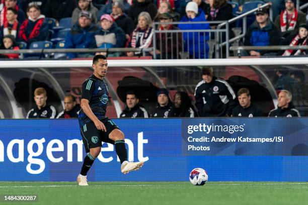 Roger Espinoza of Sporting Kansas City passes the ball during a game between Sporting Kansas City and New England Revolution at Gillette Stadium on...