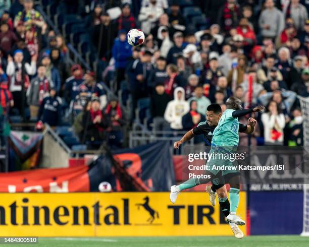 Roger Espinoza of Sporting Kansas City and Emmanuel Boateng of New England Revolution battle for head ball during a game between Sporting Kansas City...