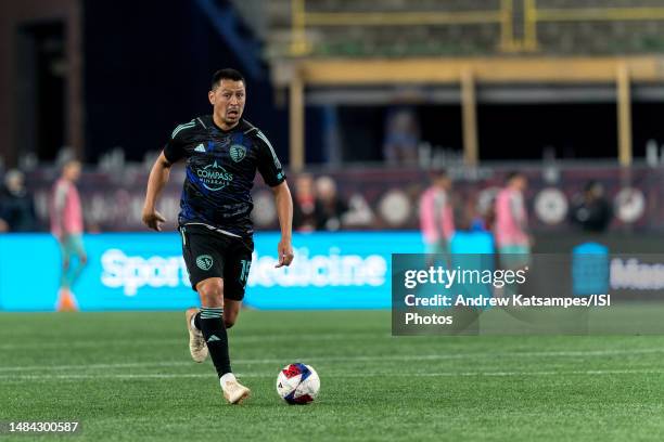 Roger Espinoza of Sporting Kansas City brings the ball forward during a game between Sporting Kansas City and New England Revolution at Gillette...