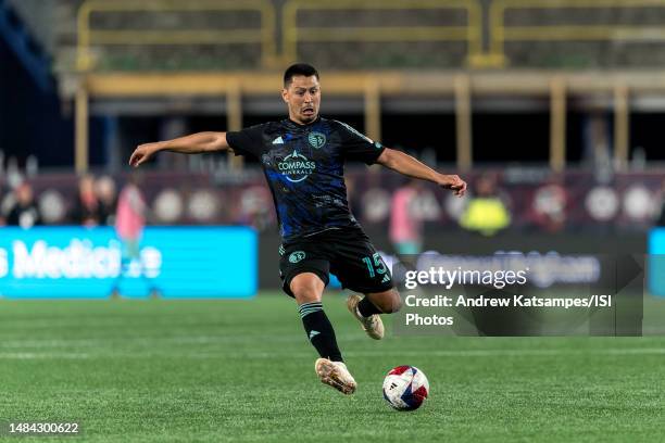 Roger Espinoza of Sporting Kansas City passes the ball during a game between Sporting Kansas City and New England Revolution at Gillette Stadium on...