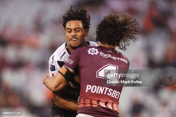 Jahream Bula of the Wests Tigers is tackled by Morgan Harper of the Sea Eagles during the round eight NRL match between Wests Tigers and Manly Sea...