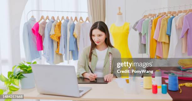 fashion designer work in studio - design studio woman chinese laptop stock pictures, royalty-free photos & images