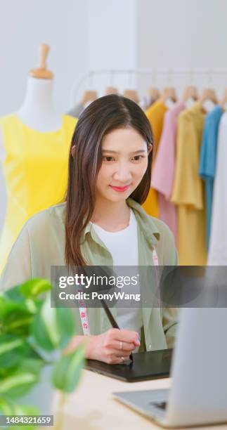 fashion designer work in studio - design studio woman chinese laptop stock pictures, royalty-free photos & images