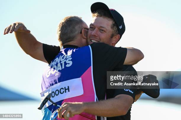 Talor Gooch of RangeGoats GC celebrates with his caddie Malcolm Baker on the 18th hole after Gooch won Liv Golf Adelaide at The Grange Golf Course on...