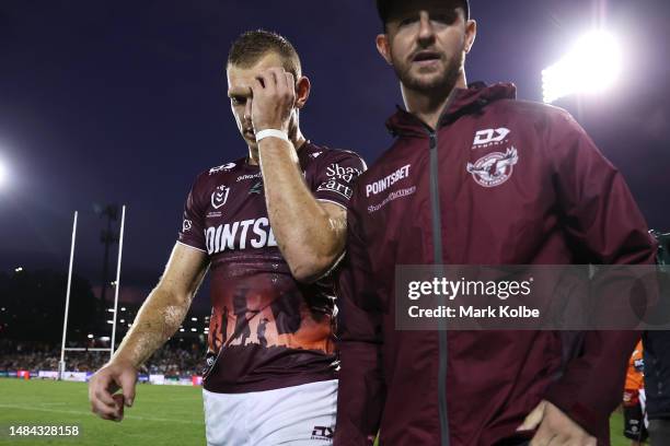 Tom Trbojevic of the Sea Eagles leave the field with the trainer during the round eight NRL match between Wests Tigers and Manly Sea Eagles at...