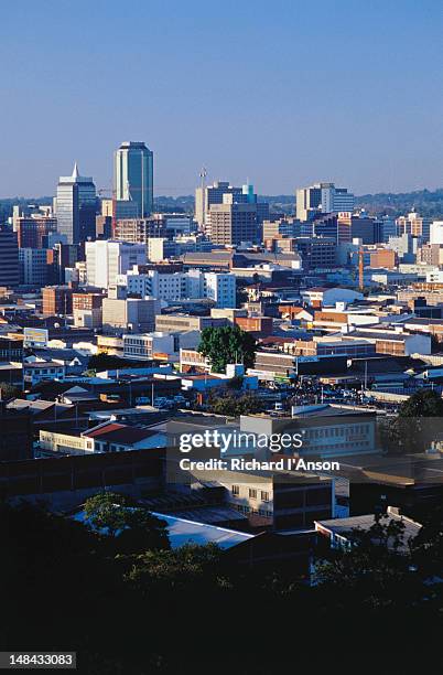 the rooftops of the suburbs surrounding the city high-rises; a view of harare from kpoje - harare stock pictures, royalty-free photos & images