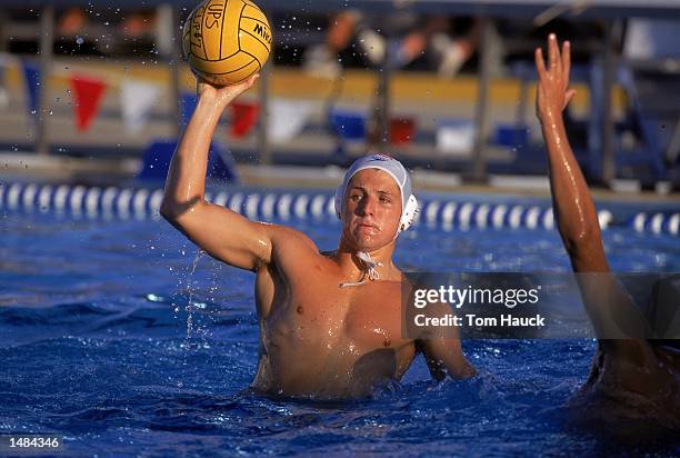 Tony Azevedo of the USA team gets ready to throw the ball while Elvis Fatovic of the Croatia Team tries to block the ball during the UPS Water Polo...