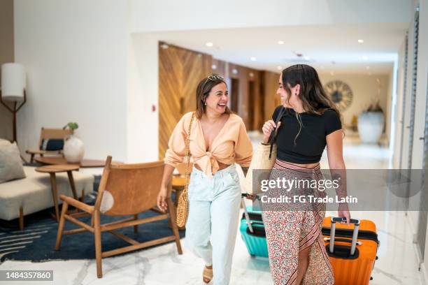 traveler friends arriving at a hotel with their luggage - hotell bildbanksfoton och bilder