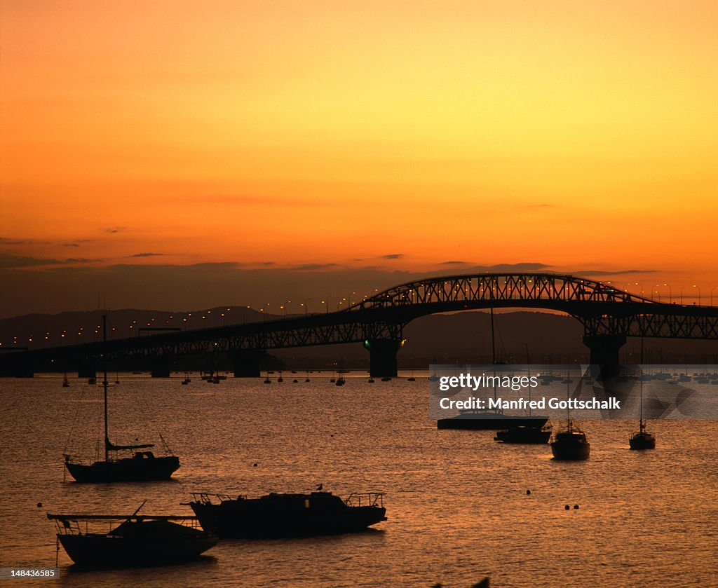 Auckland Harbour Bridge at sunset.