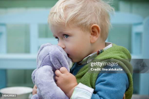 toddler holding rabbit - rabbit toy stock pictures, royalty-free photos & images