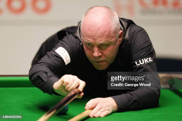John Higgins of Scotland plays a shot during their round two match against Kyren Wilson of England on Day Nine of the Cazoo World Snooker...