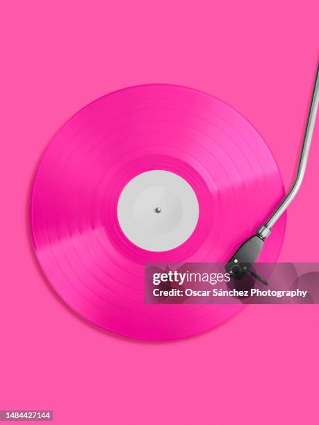 top view of a vinyl record in pink colors - turn stock pictures, royalty-free photos & images