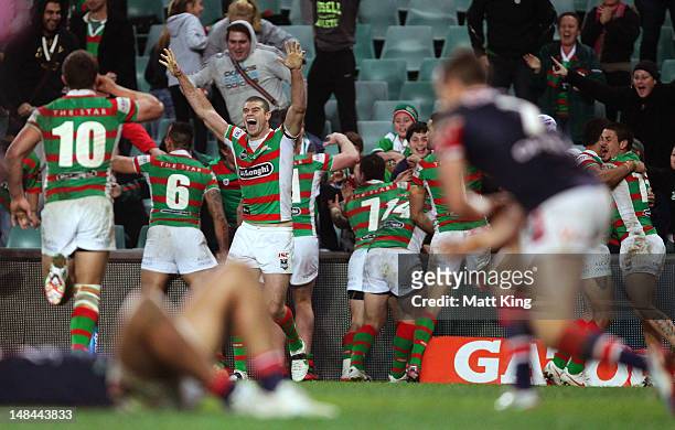 Matt King of the Rabbitohs celebrates with team mates after the final try during the round 19 NRL match between the Sydney Roosters and the South...