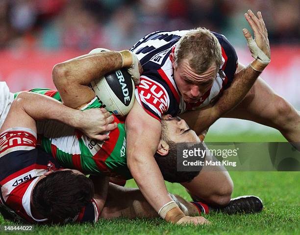 Greg Inglis of the Rabbitohs is tackled during the round 19 NRL match between the Sydney Roosters and the South Sydney Rabbitohs at Allianz Stadium...