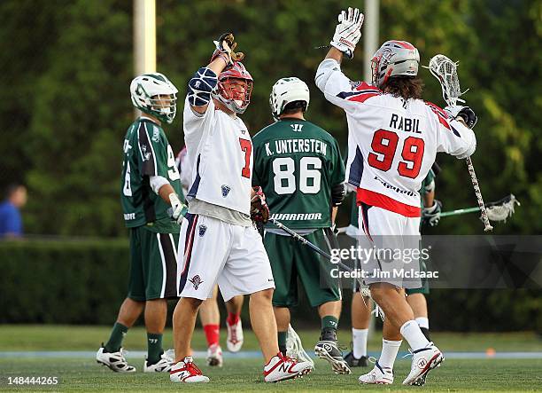 Matt Poskay of the Boston Cannons celebrates scoring a goal against the Long Island Lizards with teammate Paul Rabil during their Major League...