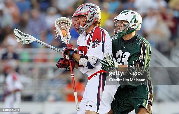 Mike Ward of the Long Island Lizards defends against Mike Stone of the Boston Cannons during their Major League Lacrosse game on July 14, 2012 at...