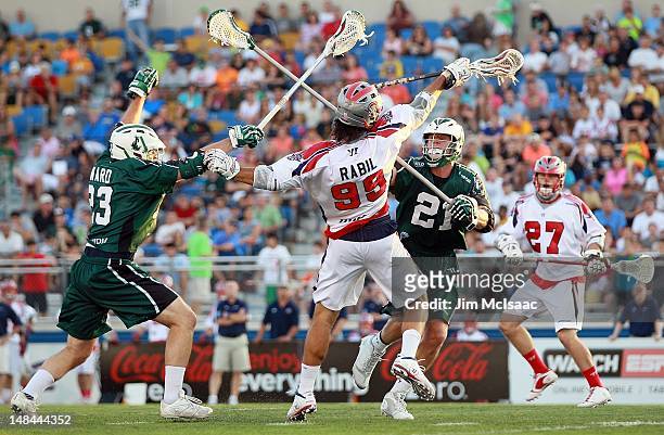 Tim Henderson and Mike Ward of the Long Island Lizards defend against Paul Rabil of the Boston Cannons during their Major League Lacrosse game on...