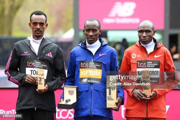 Third place finisher Tamirat Tola of Ethiopia, first place finisher Kelvin Kiptum of Kenya and second place finisher Geoffrey Kamworor of Kenya pose...