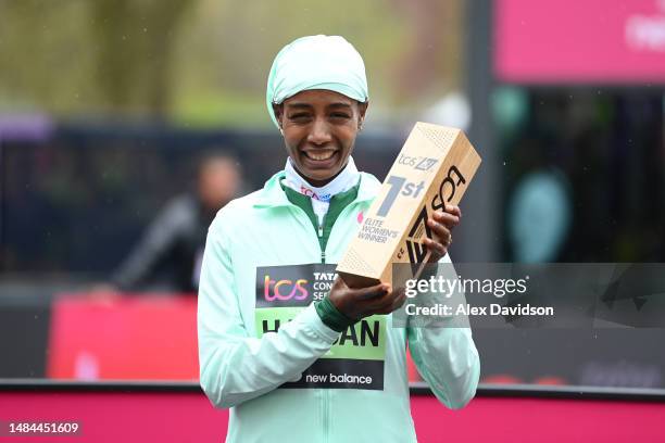 Sifan Hassan of Netherlands poses for a photo with their trophy after winning the Elite Woman's Marathon during the 2023 TCS London Marathon on April...