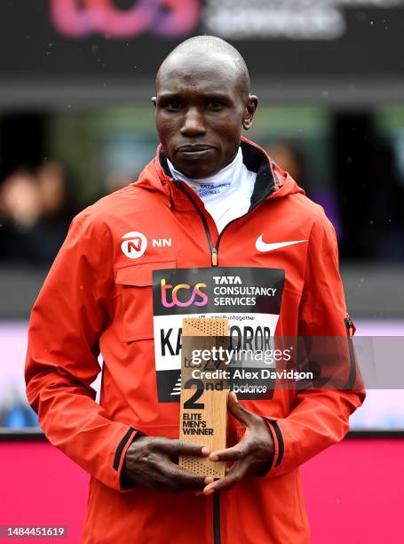 Geoffrey Kamworor of Kenya poses for a photo with the 2nd place trophy after finishing 2nd in the Elite Men's Marathon during the 2023 TCS London...