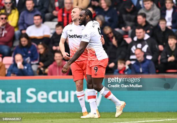 Michail Antonio of West Ham United celebrates with teammate Jarrod Bowen after scoring the team's first goal during the Premier League match between...
