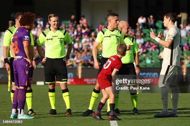 Referee Jack Morgan talks with Craig Goodwin of Adelaide following the coin toss during the round 25 A-League Men's match between Perth Glory and...