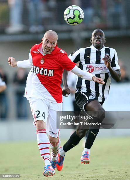 Demba Ba of Newcastle challenges Andrea Raggi of Monaco during a pre season friendly match between Newcastle United and AS Monaco at the...