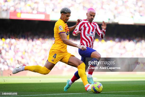 Antoine Griezmann of Atletico Madrid battles for possession with Ronald Araujo of FC Barcelona during the LaLiga Santander match between FC Barcelona...