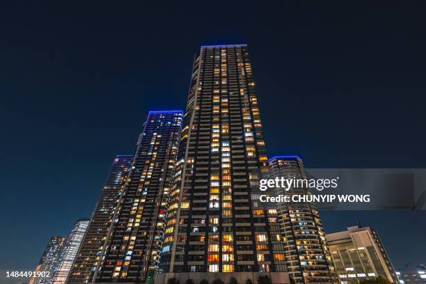 high-rise apartment in toyosu, koto ward, tokyo at night - chuo ward tokyo stock pictures, royalty-free photos & images