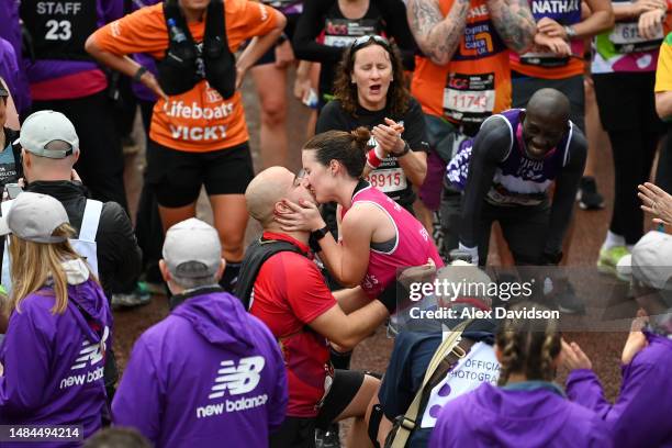 Couple embrace after a proposal on the finish line during the 2023 TCS London Marathon on April 23, 2023 in London, England.