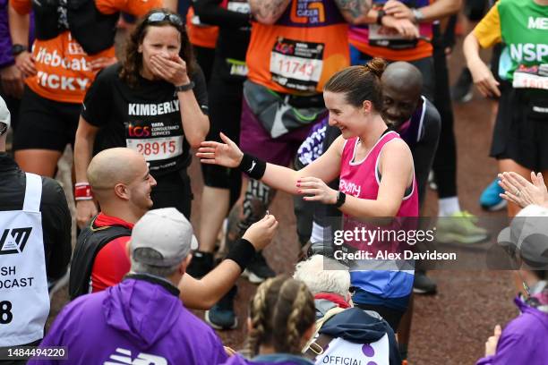 Couple embrace after a proposal on the finish line during the 2023 TCS London Marathon on April 23, 2023 in London, England.