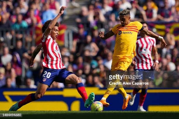 Axel Witsel of Atletico Madrid battles for possession with Raphinha of FC Barcelona during the LaLiga Santander match between FC Barcelona and...