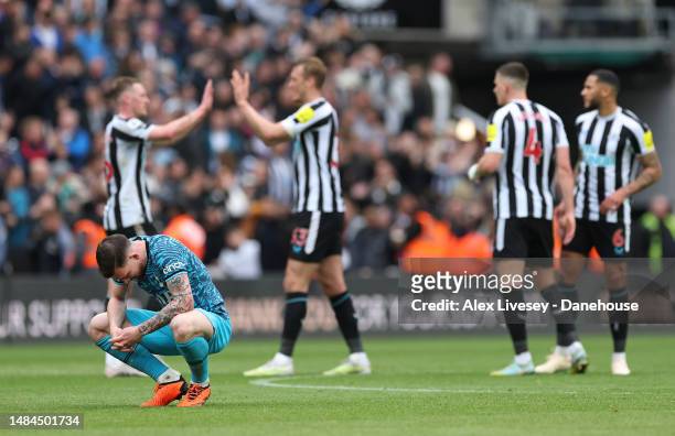 Pierre-Emile Hojbjerg of Tottenham Hotspur looks dejected as Newcastle United players celebrate after the Premier League match between Newcastle...